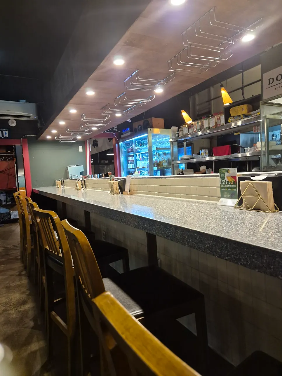 The chef cooking, visible from the open kitchen at Don Tamguso