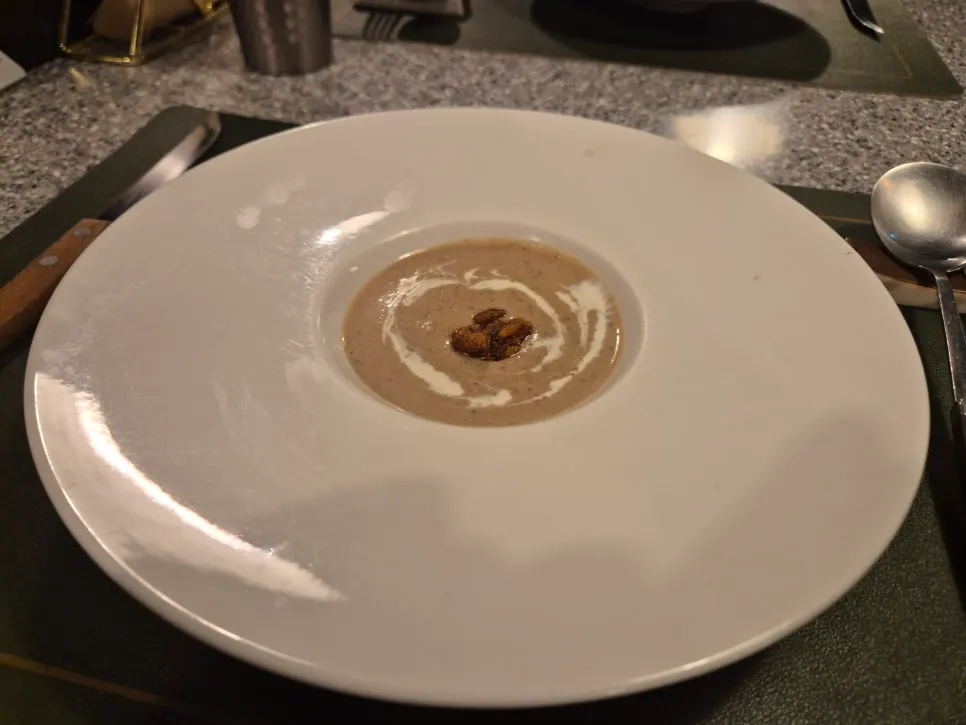Chestnut and mushroom cream soup topped with nuts
