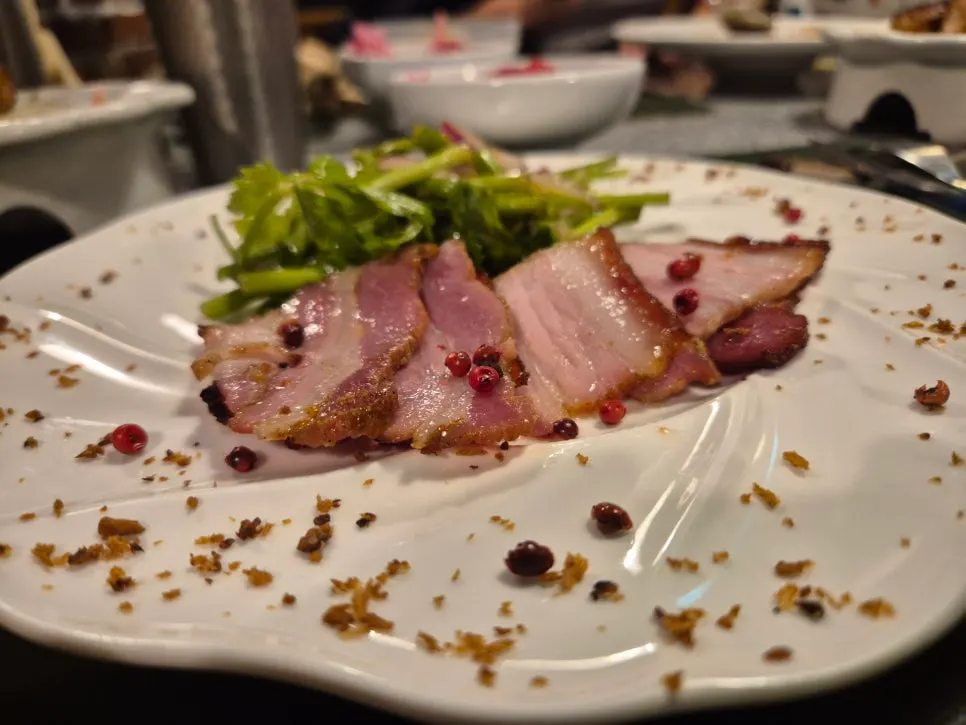 Plating of oven-roasted pork belly inspired by Peking duck