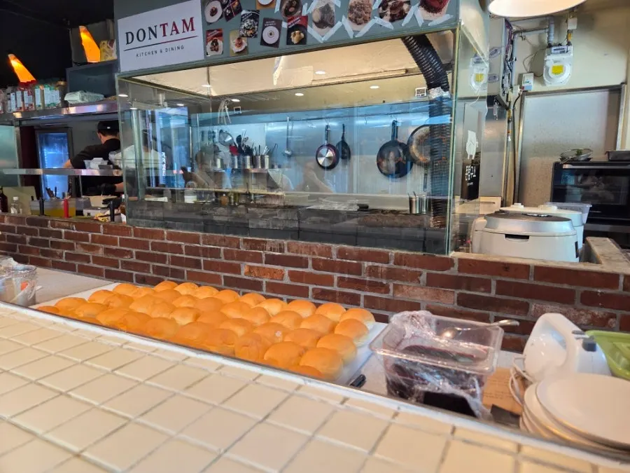 Bar table and open kitchen at Don Tamguso