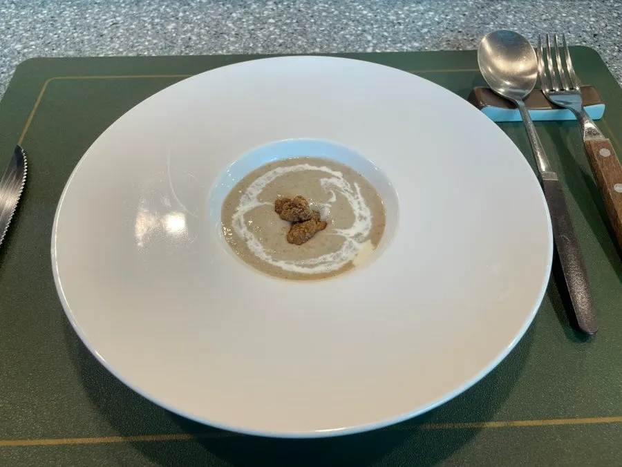 The course's first dish, a chestnut mushroom cream soup