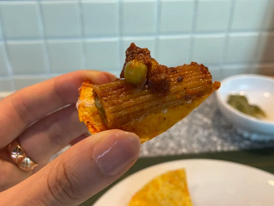 Rigatoni piled onto a nacho chip to eat wrapped