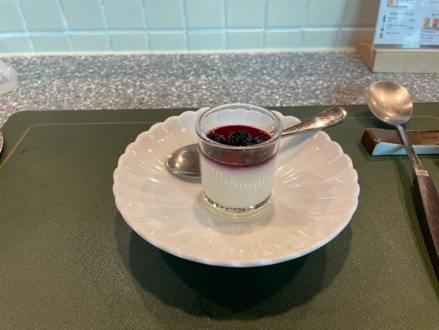 Milk pudding dessert topped with blueberry jam