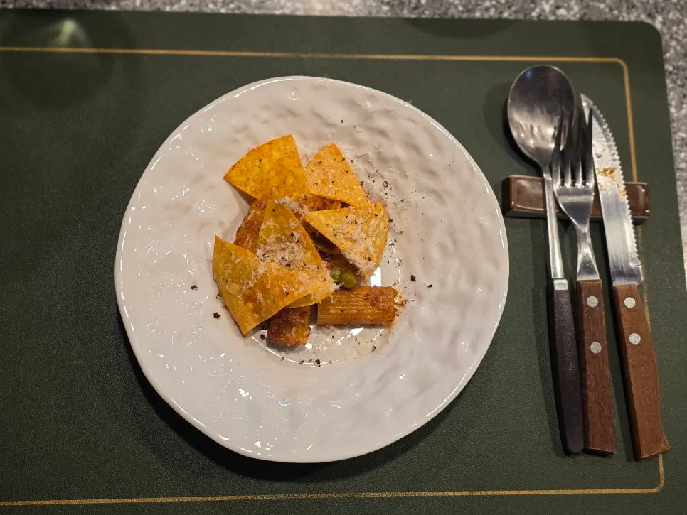 Rigatoni topped with nachos and cheese