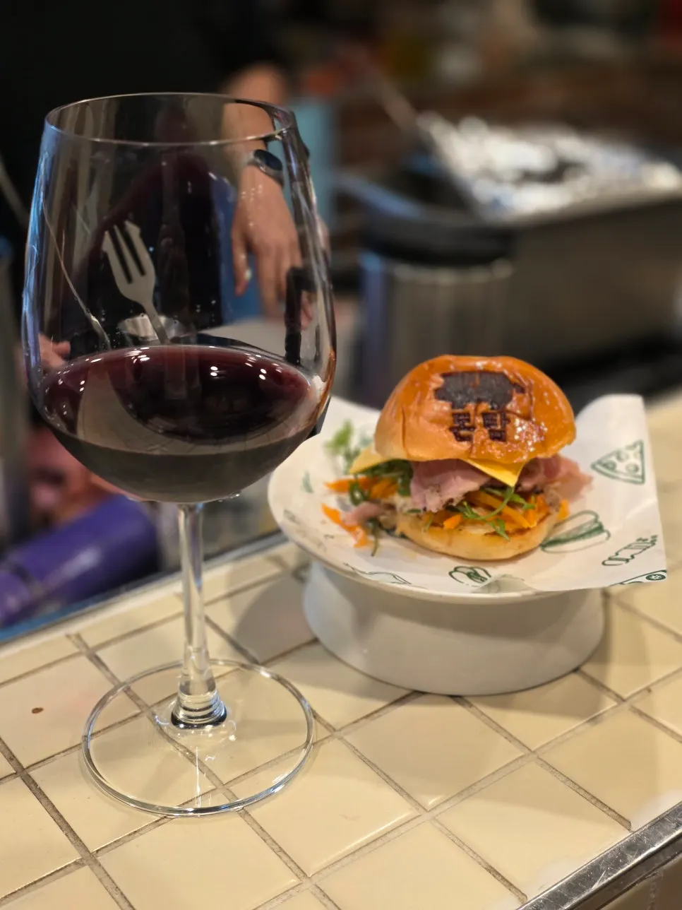 Signature burger with the restaurant's name stamped on the bun