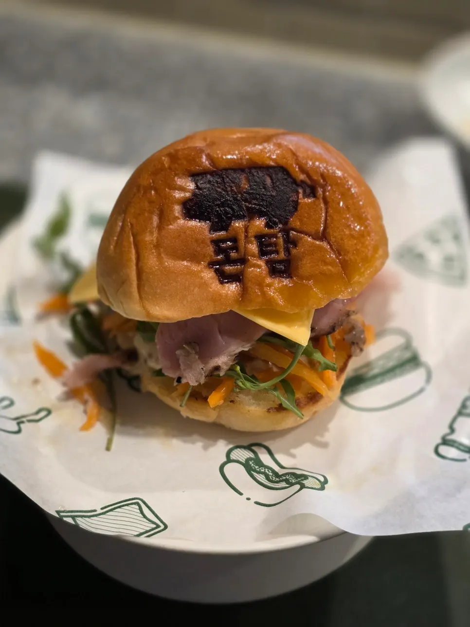 Cross-section of the signature burger with jambon and arugula