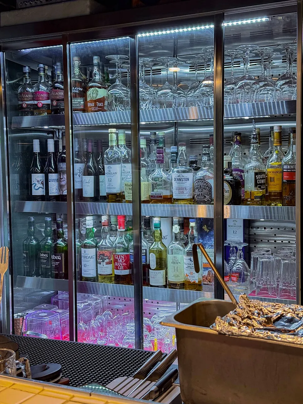 Bar table and open kitchen interior at Don Tamguso
