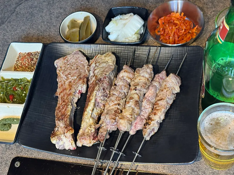 Staff grilling lamb shoulder rack