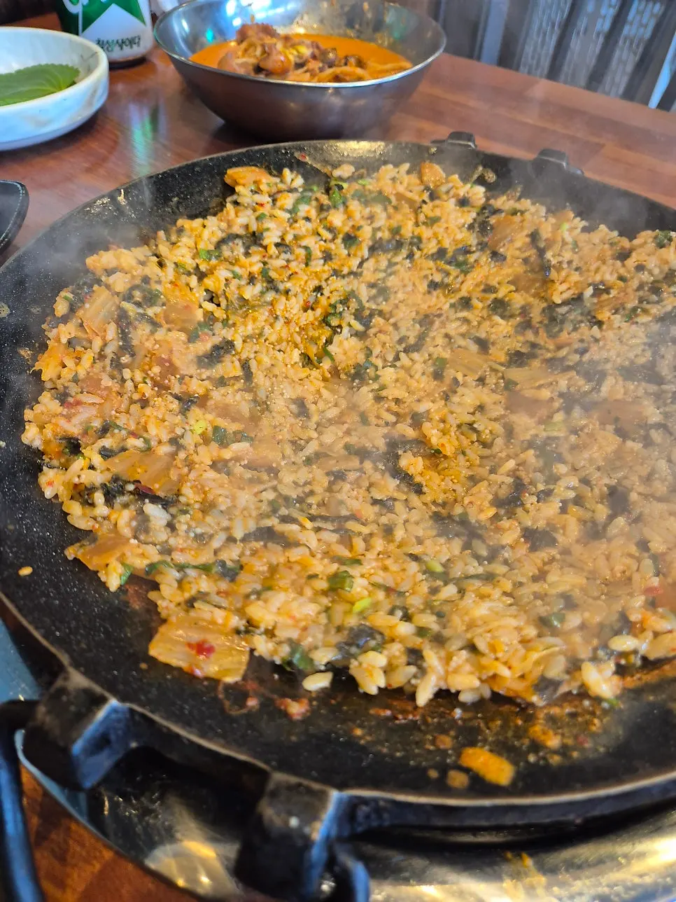 A staff member stir-frying flying-fish-roe fried rice