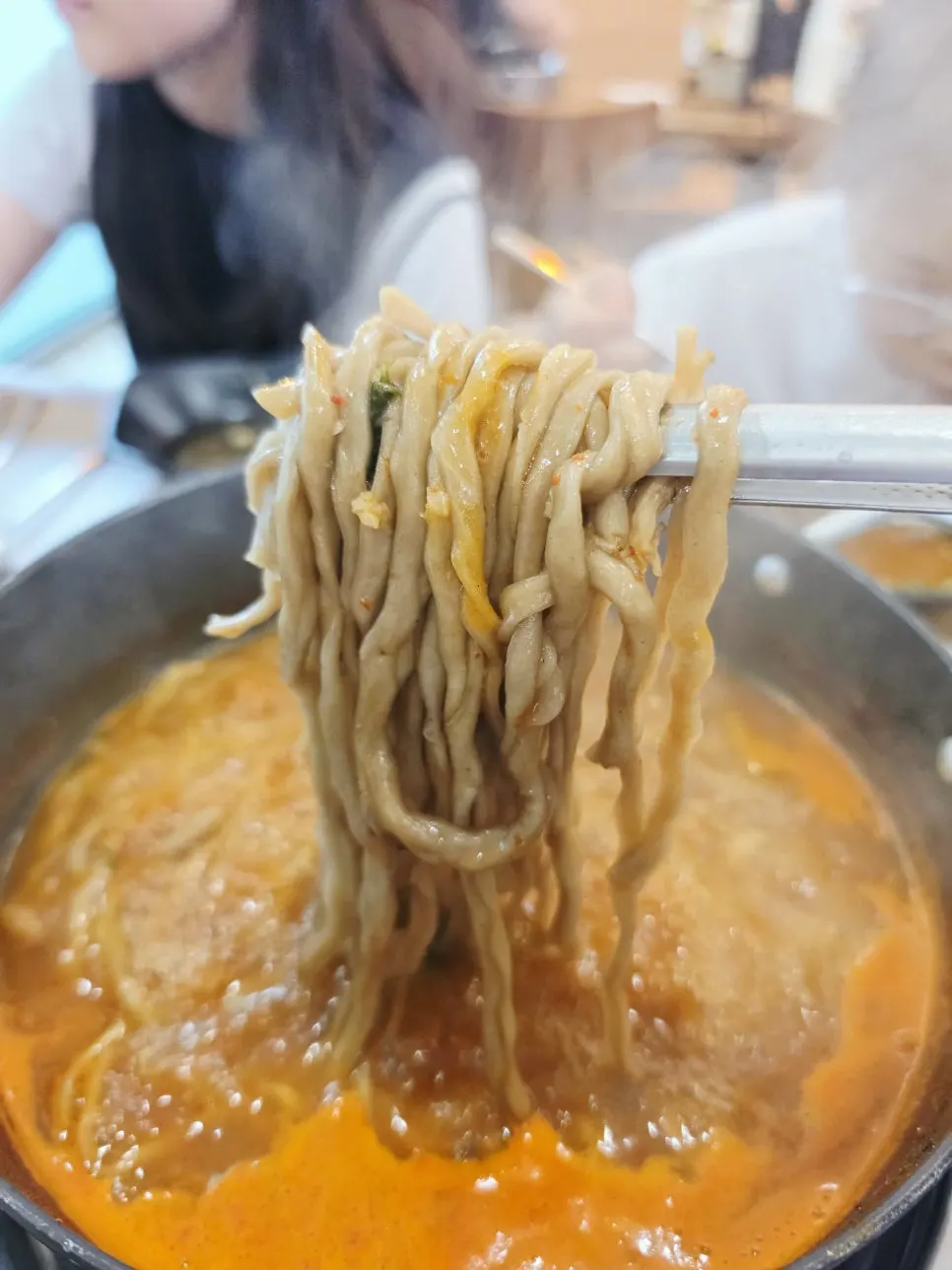 Black garlic hand-cut noodles boiled in the spicy broth