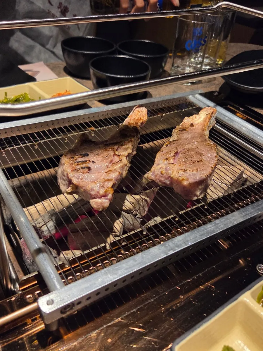 Staff grilling lamb shoulder rack