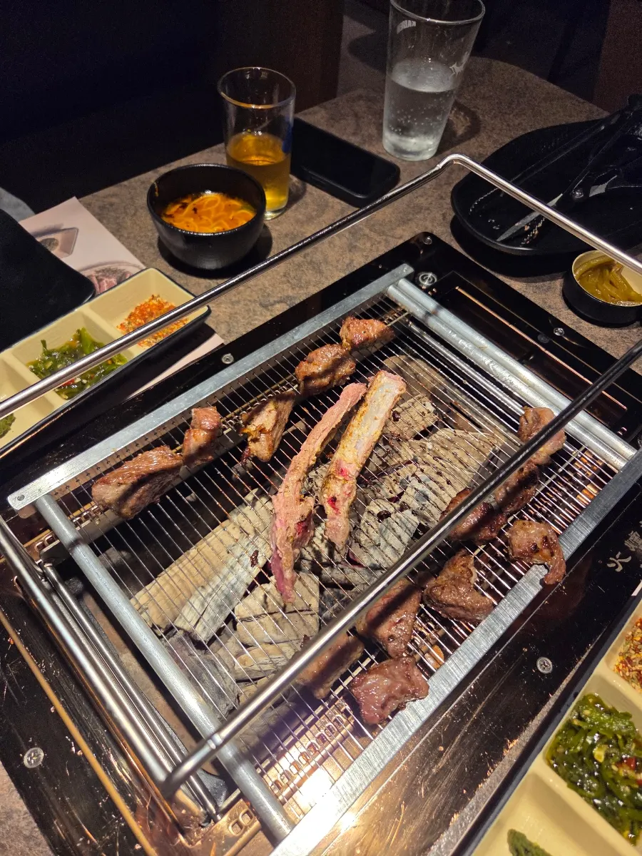 Staff grilling lamb shoulder rack