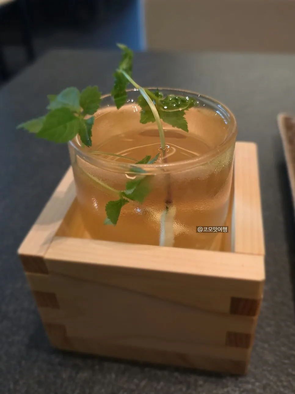 Ginseng liquor in a masu cup