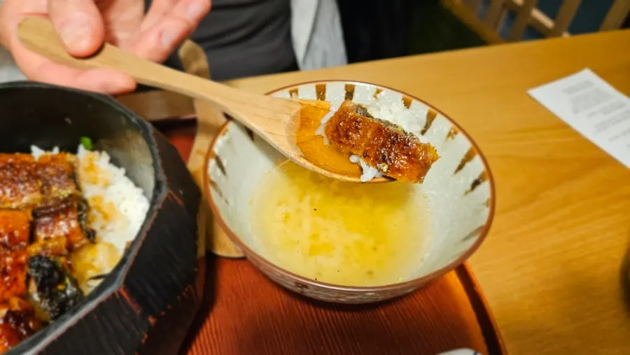 Finishing an eel rice bowl meal