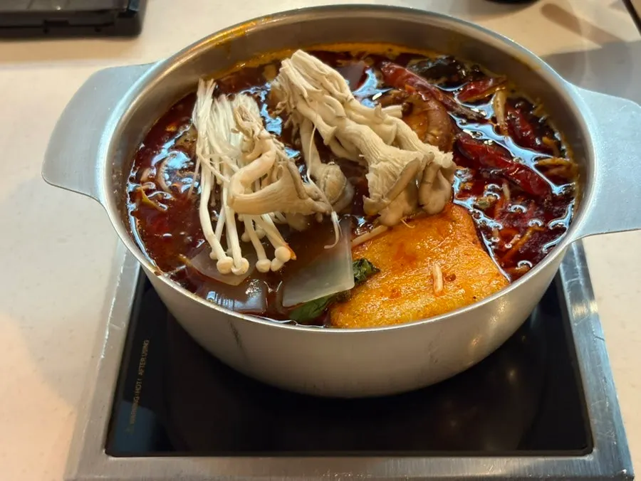 Mala hot pot pot simmering with ingredients