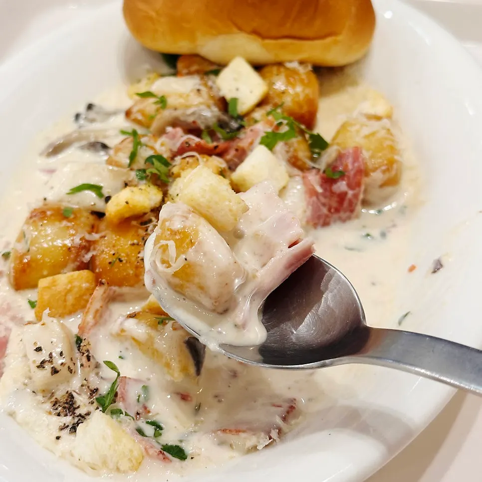 A spoonful of cream gnocchi lifted up