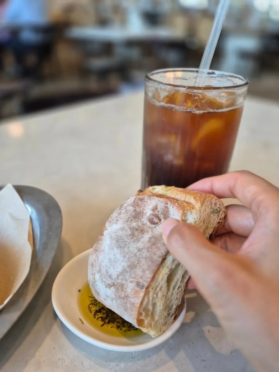 Dipping pre-meal bread into olive oil