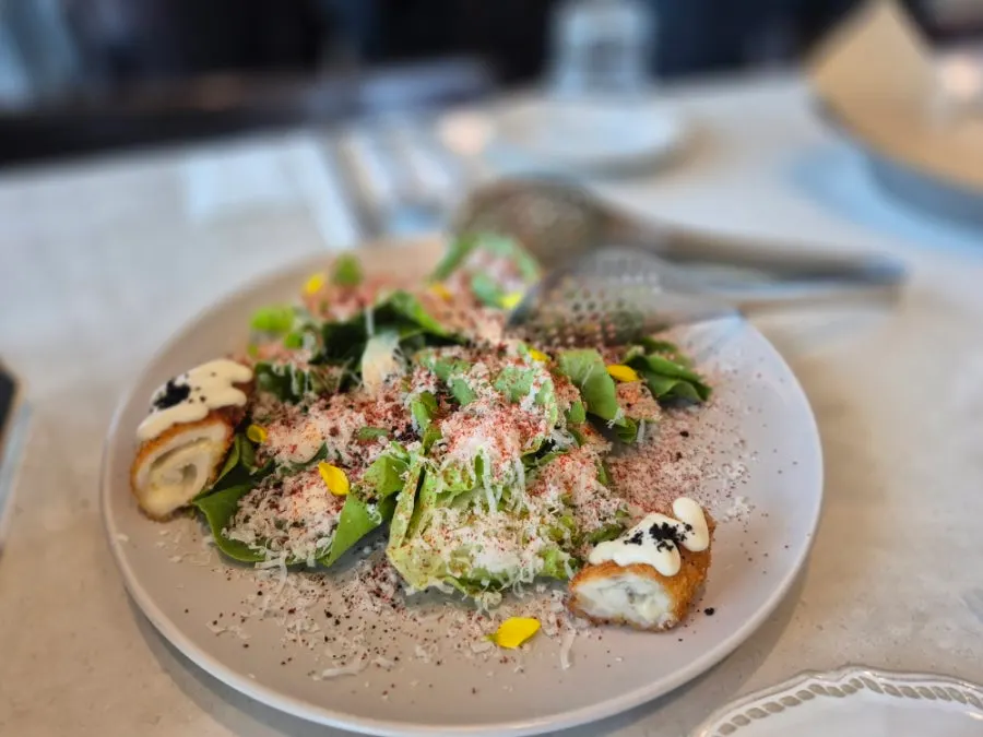 Plating of Romaok's chicken cordon Caesar salad