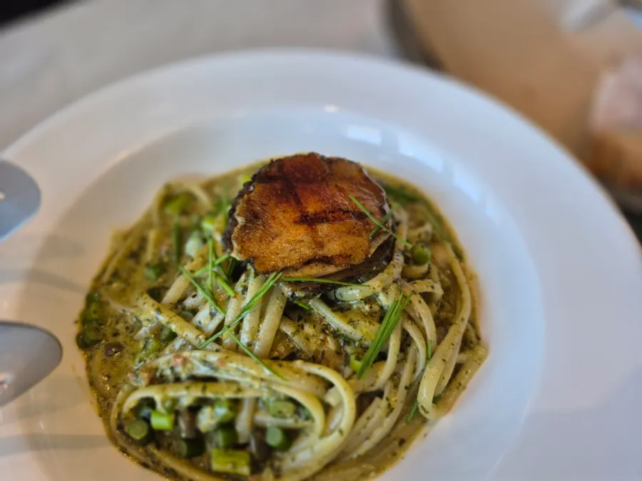Linguine in gewu sauce with a large piece of abalone