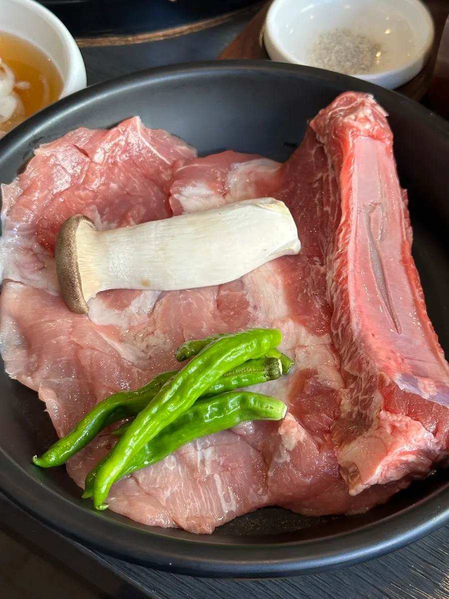 Picking up a bite of yukhoe with chopsticks