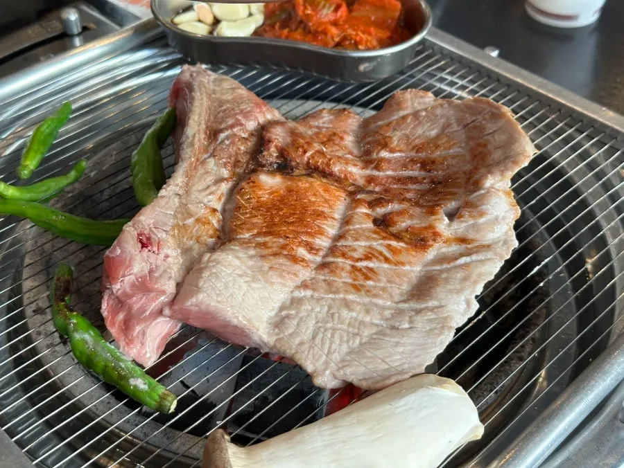 Handon fresh galbi placed on the charcoal grill
