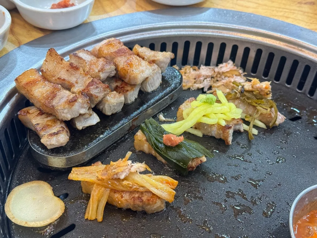 Meat cooking on the grill at Mat Chandeul Wang Sogeum Gui Yangju Branch