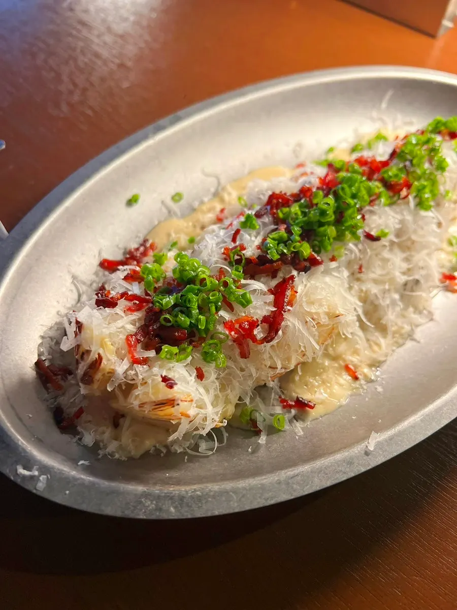 Seared napa cabbage topped with bacon and scallions