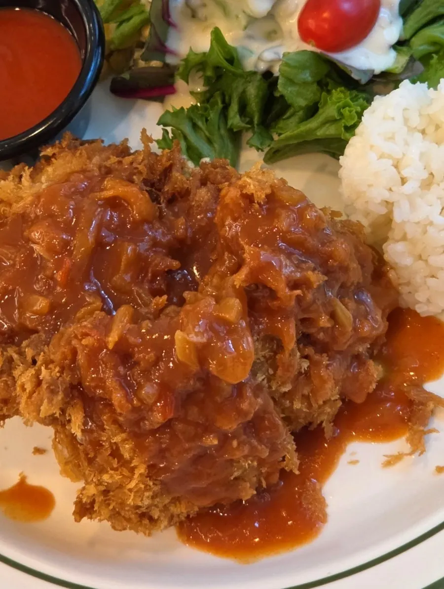 Tteudon chicken cutlet served with sauce poured on