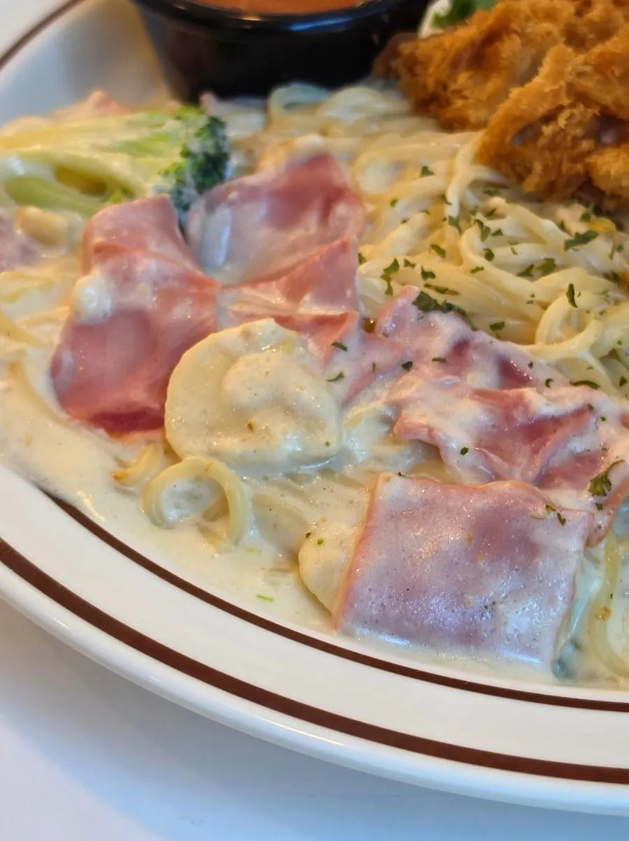 Cream pasta noodles generously loaded with bacon
