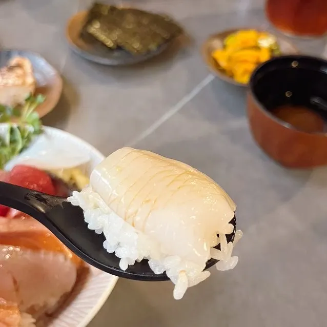 A bite of whitefish placed on rice