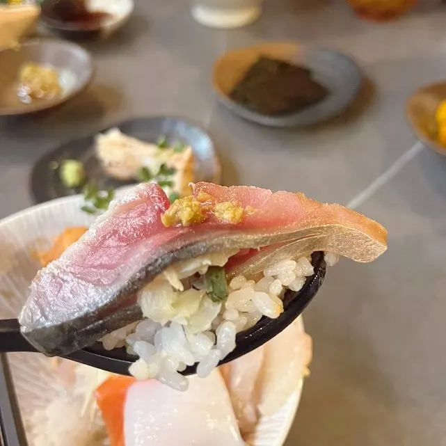 A bite of uni topped with ankimo