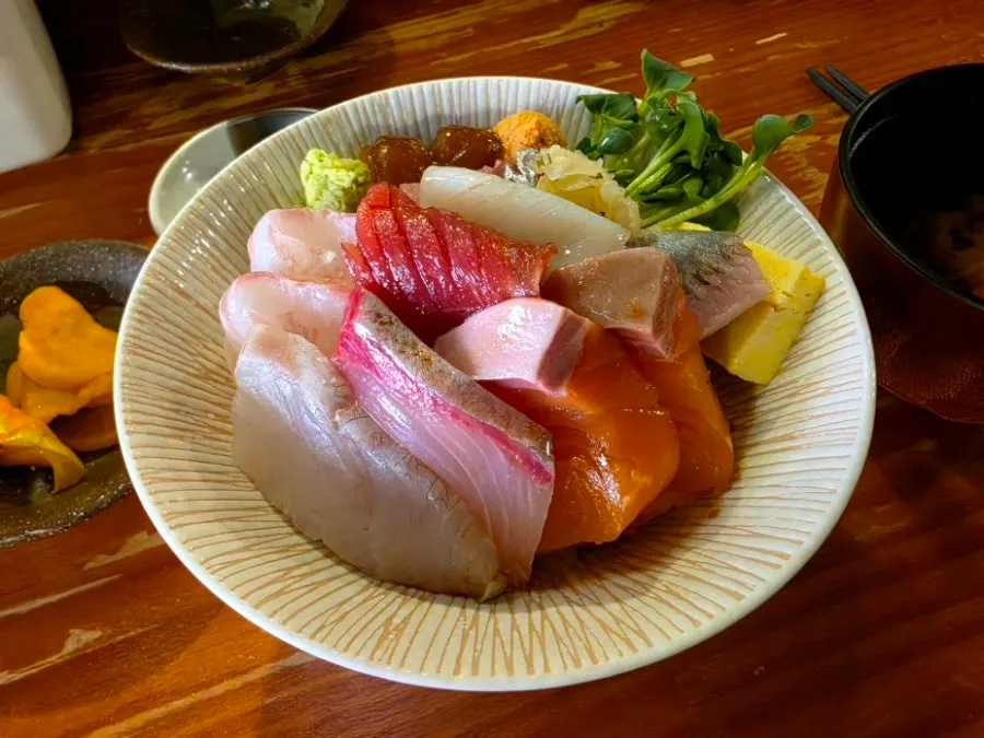 Close-up of kaisendon topped with sashimi, rolled egg and ankimo