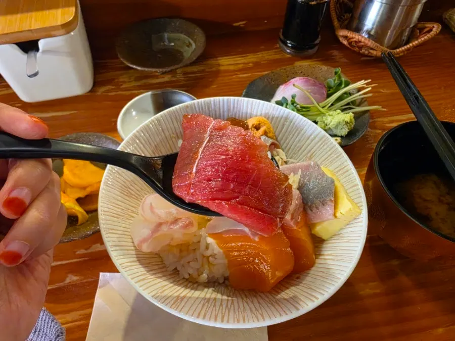 A piece of sushi topped with thick sashimi