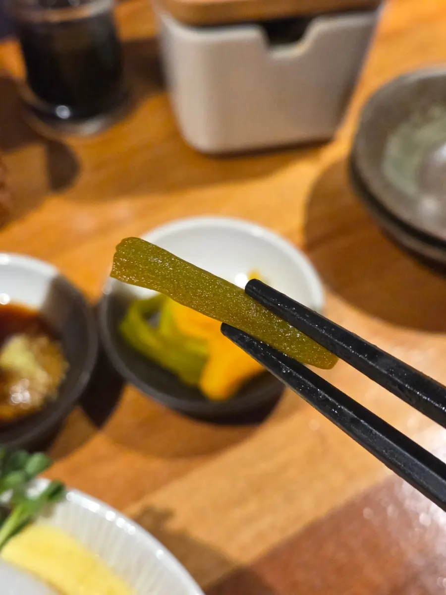 A bite of sashimi over rice made sushi-style