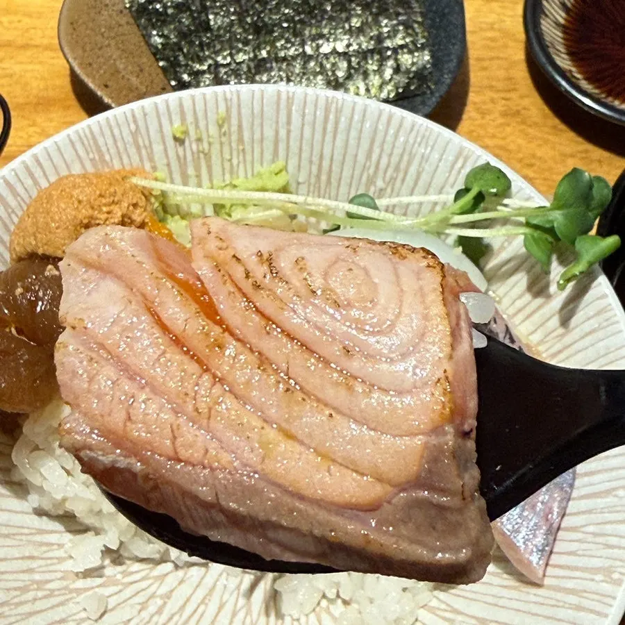 A piece of sashimi with a torched exterior