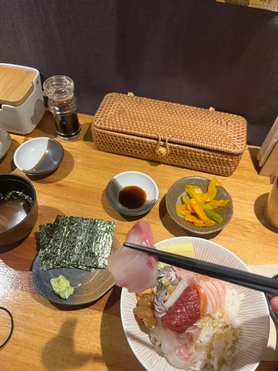 A bite of rice topped with sashimi