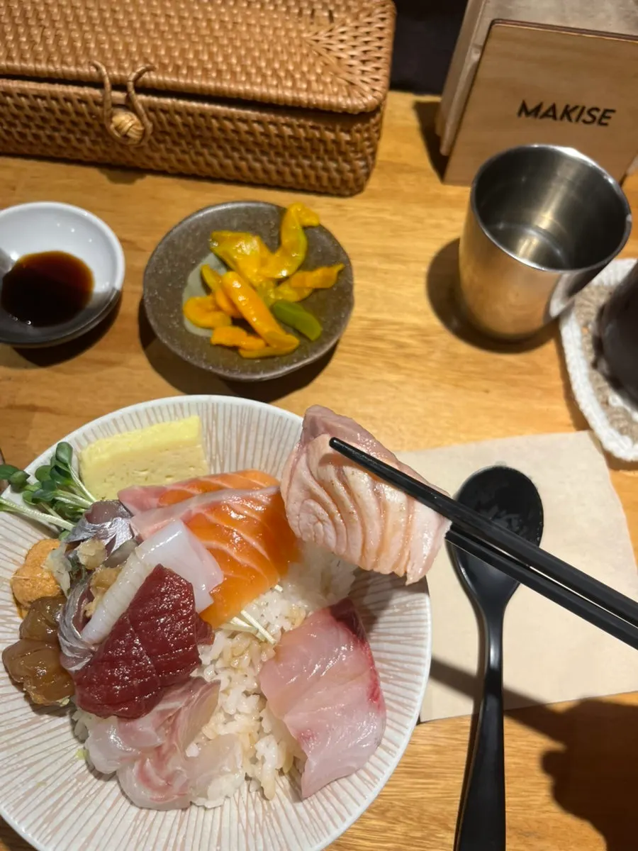 A spoonful of rice topped with yellowtail