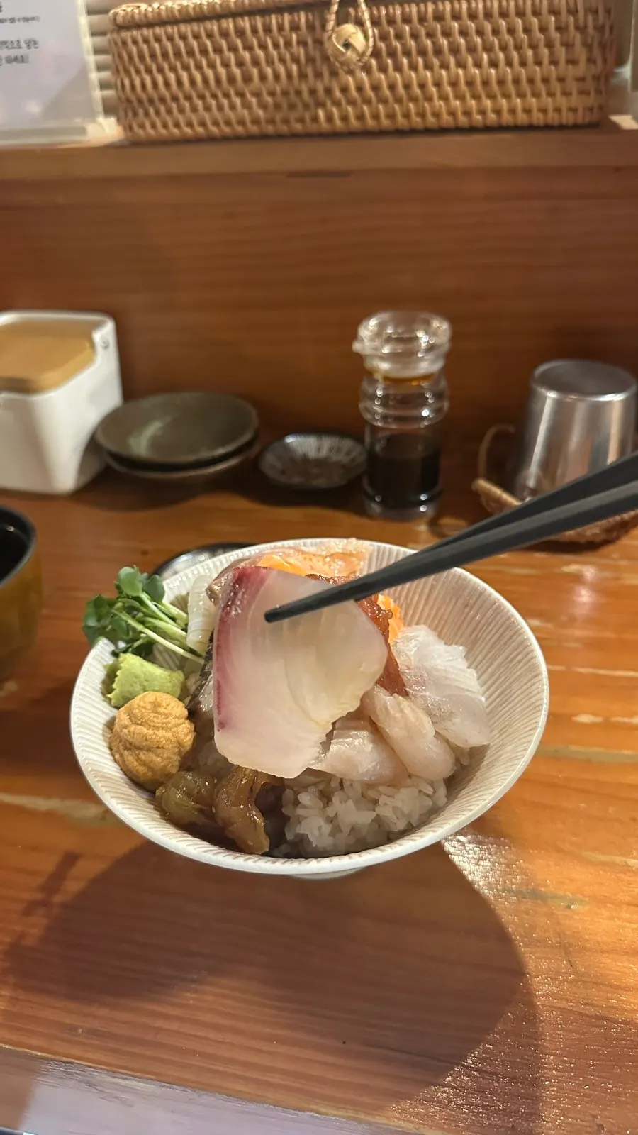 A piece of sashimi over wasabi-topped rice