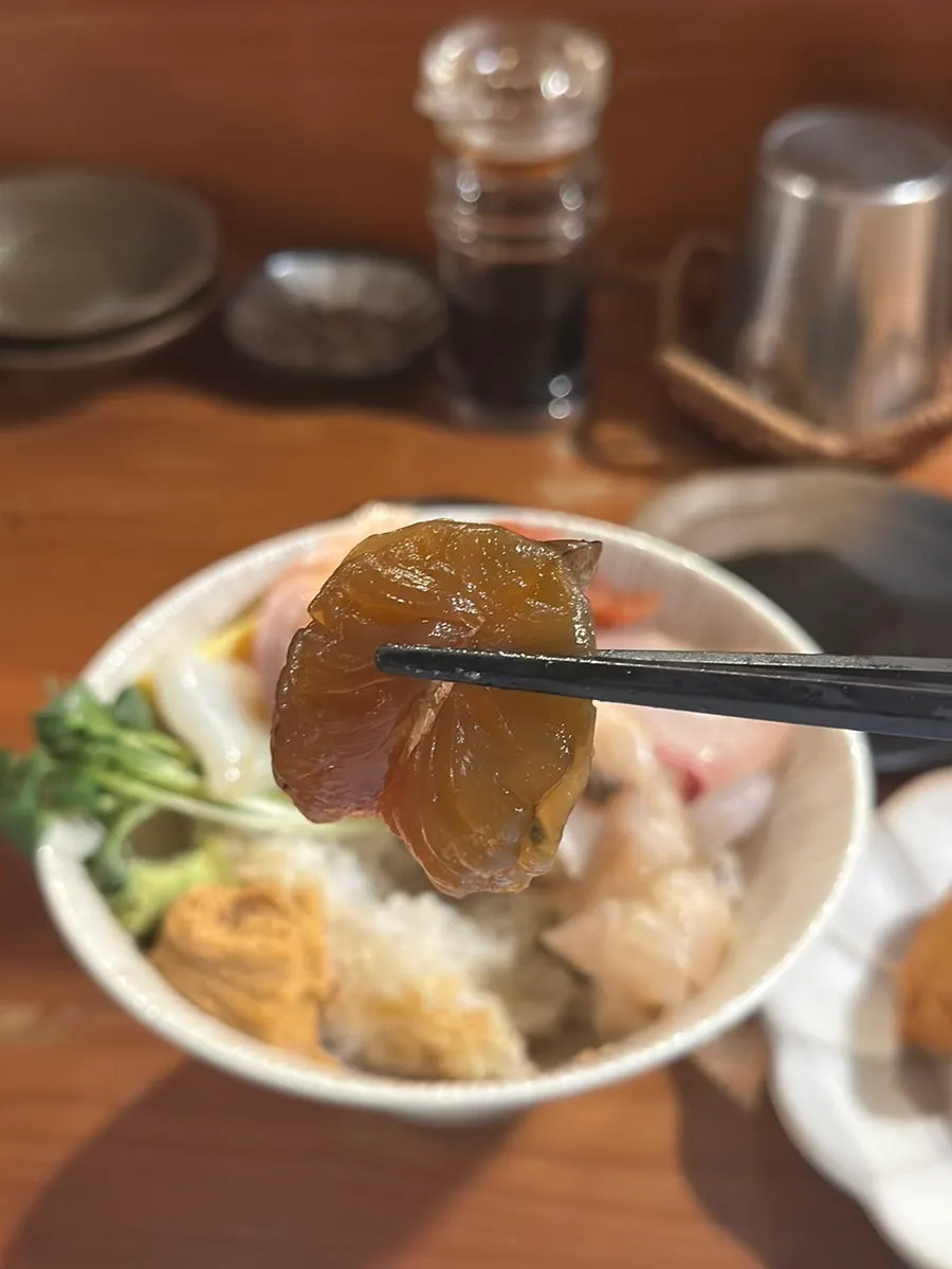 A small piece of sushi built on a spoon