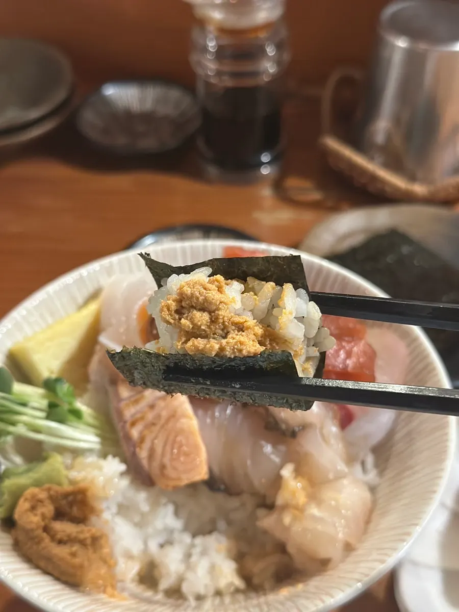 A bite of sashimi with a touch of wasabi