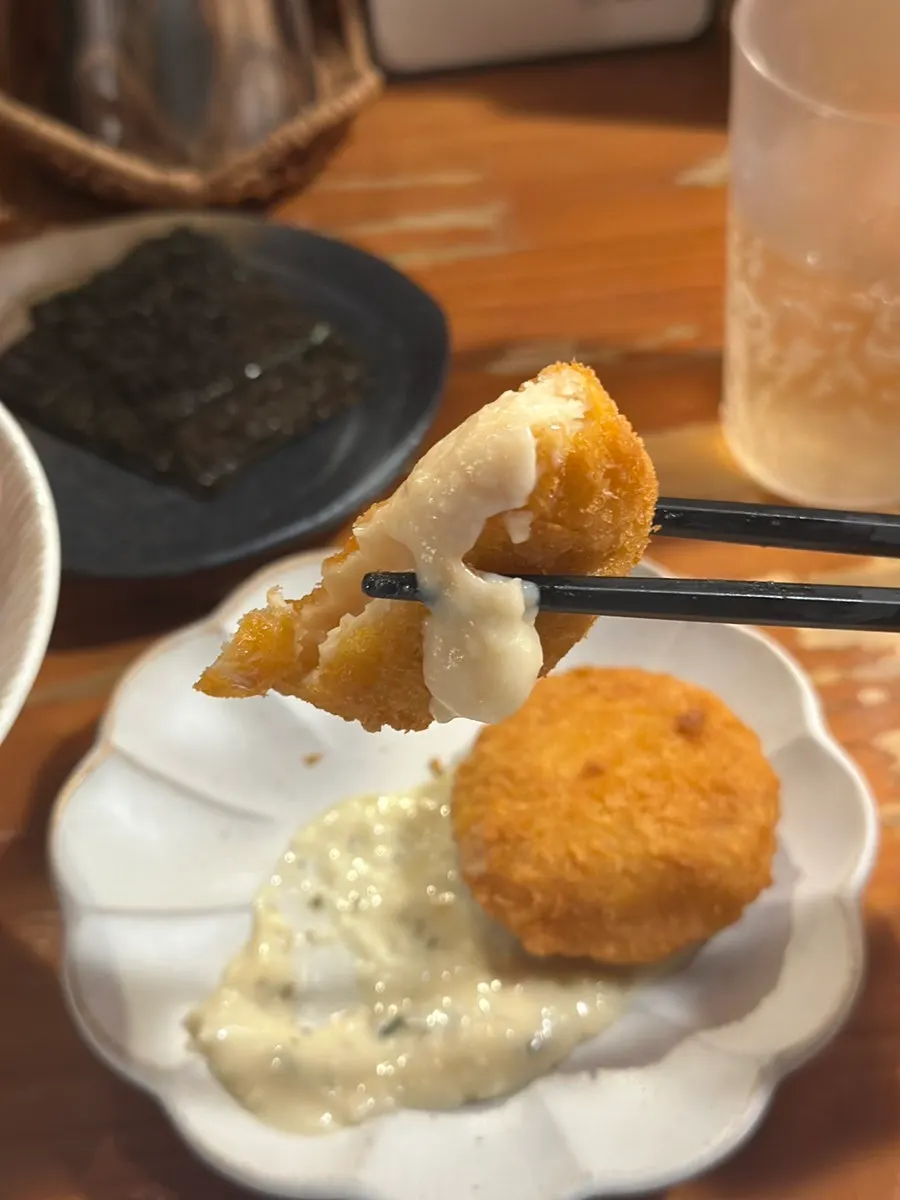 Crab cream croquette split in half showing the filling