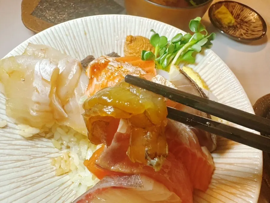 A bite of white fish placed on rice