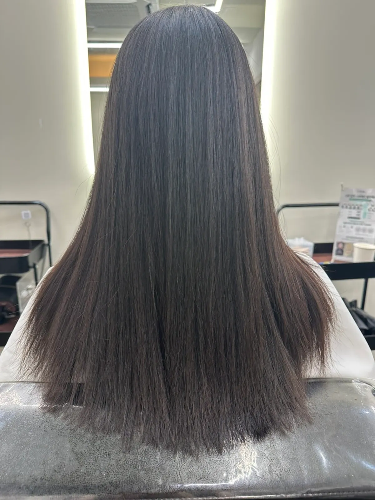 Neutralizer being applied to the hair