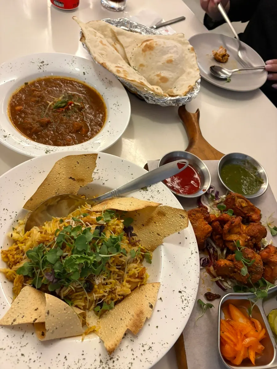 Table spread with curry and naan together