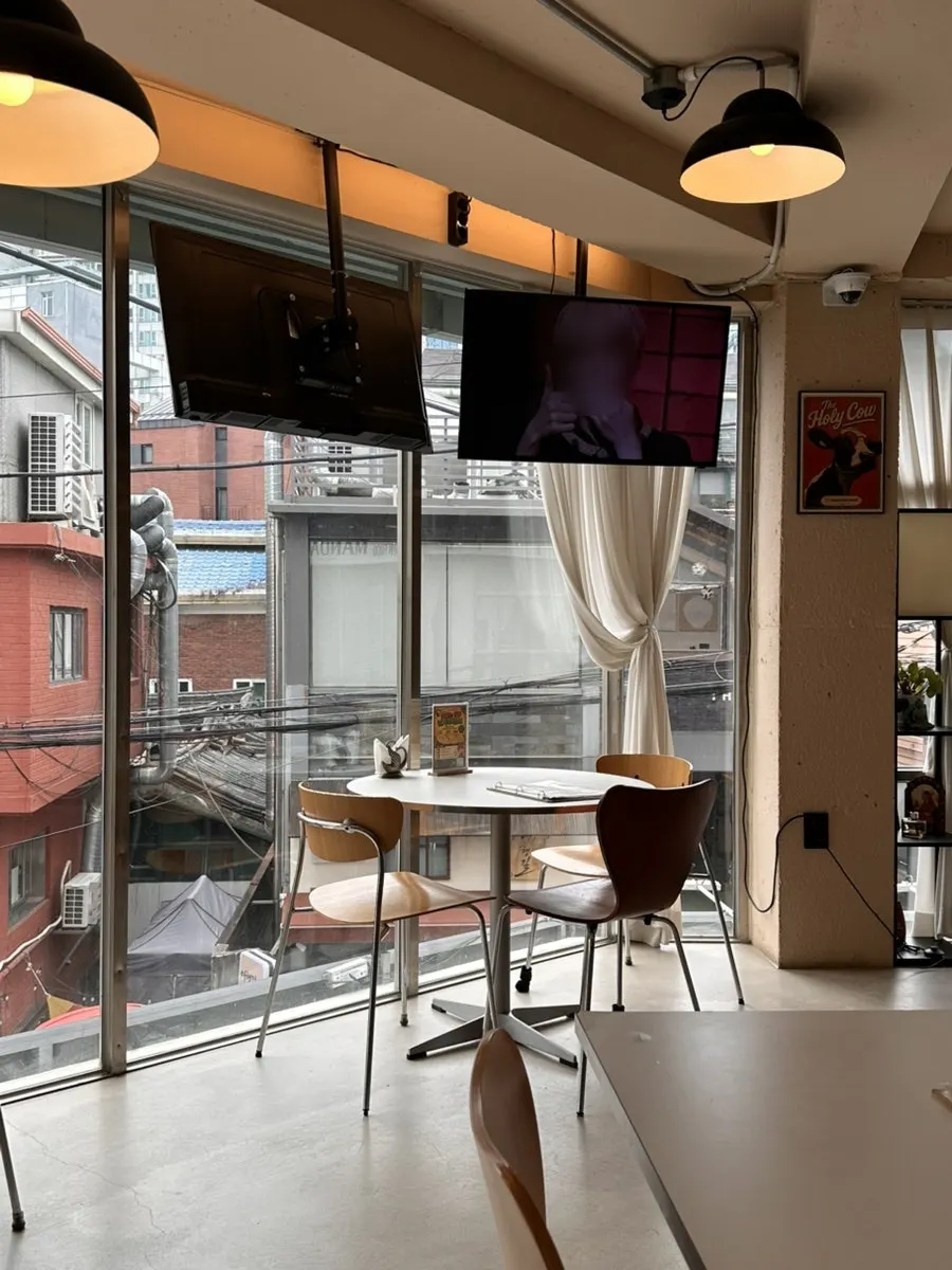 Interior of Mandala Indian Lounge with bright floor-to-ceiling windows