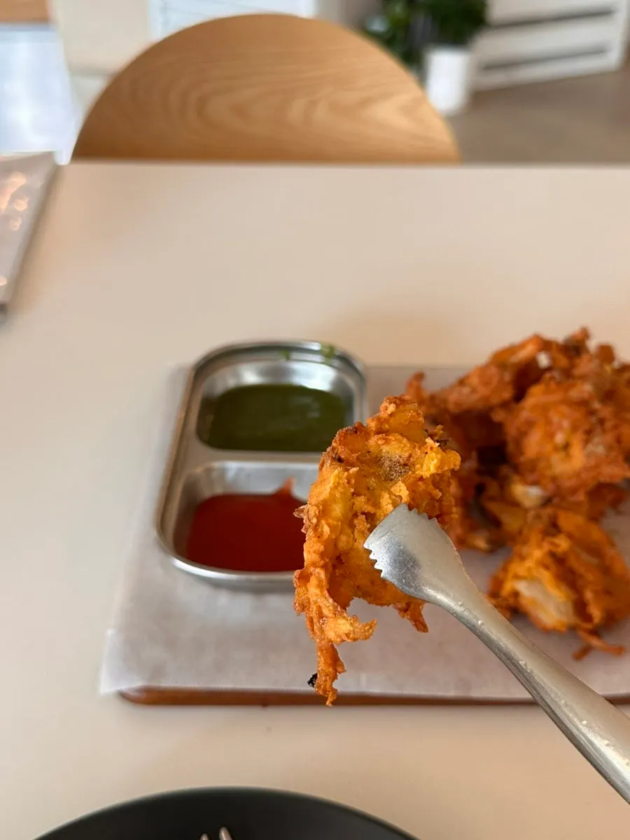Onion fritters served with dipping sauce