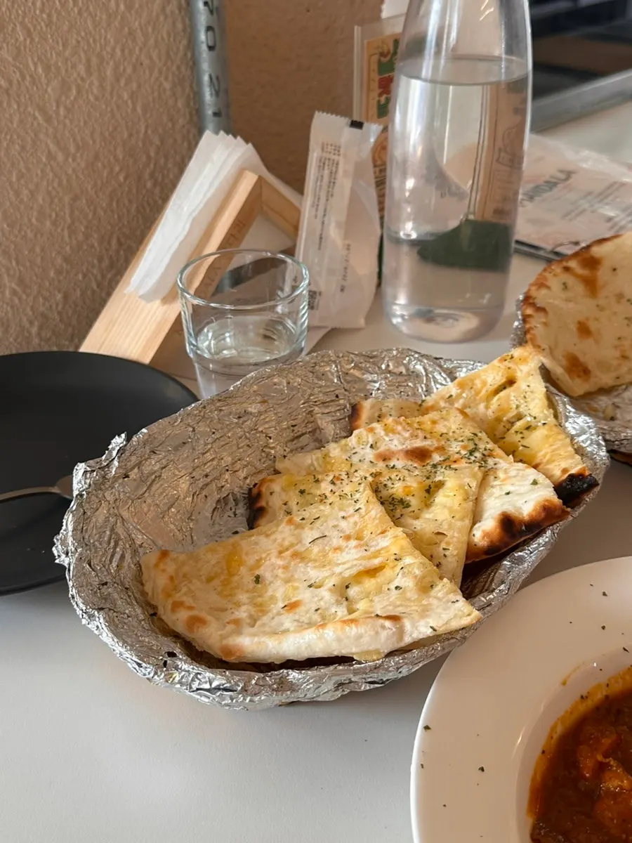The full spread of curry and naan on the table