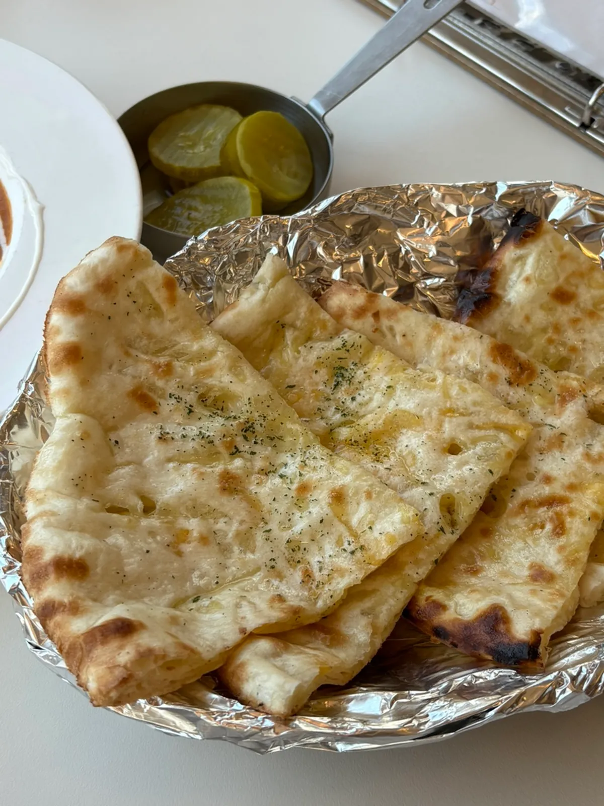 Full spread of cheese naan and chicken makhani curry