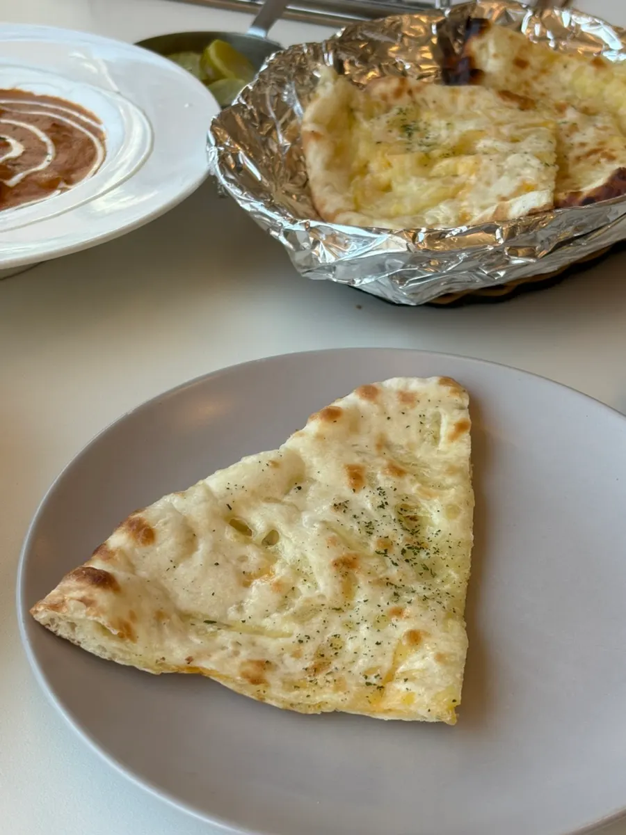 Cross-section of torn cheese naan