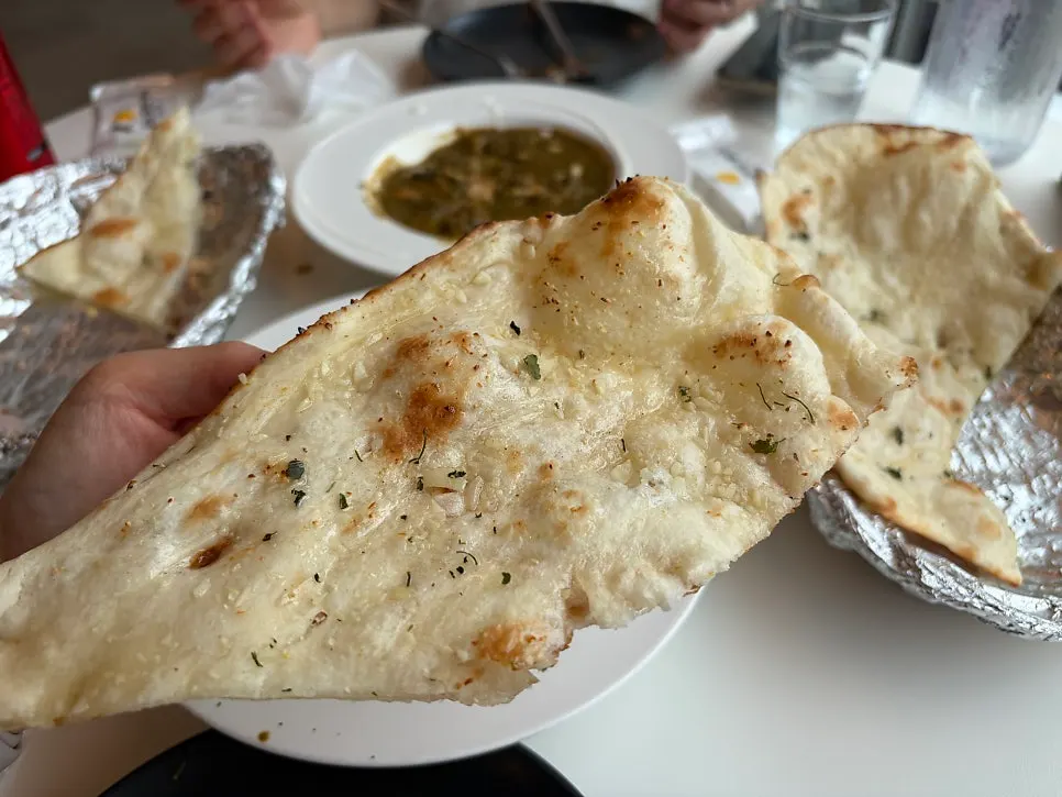 Dipping naan into curry